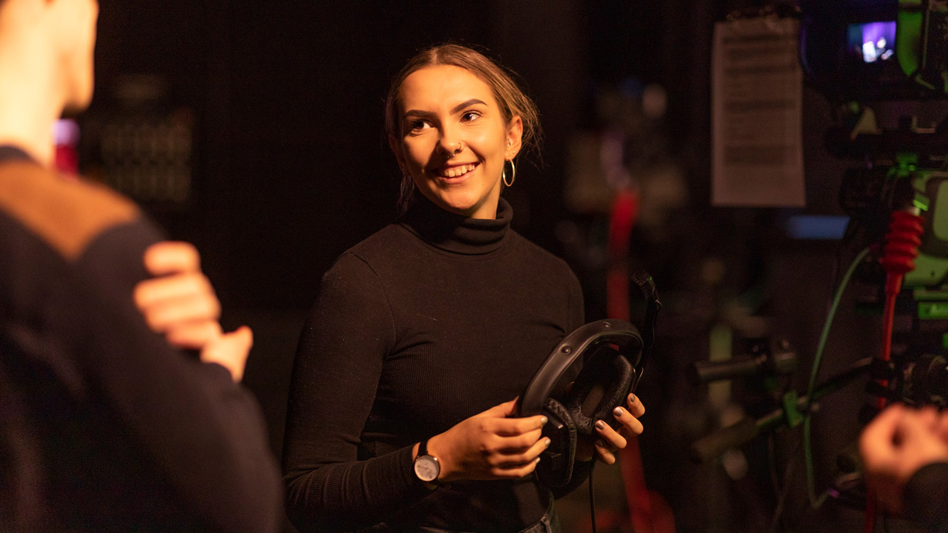 a women holding headphones