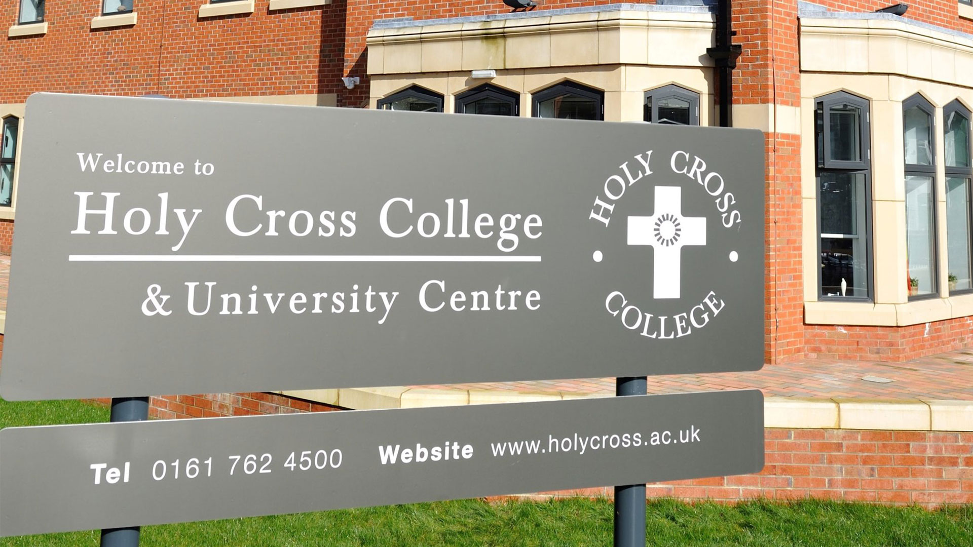 A sign that says Holy Cross College and University Centre. 