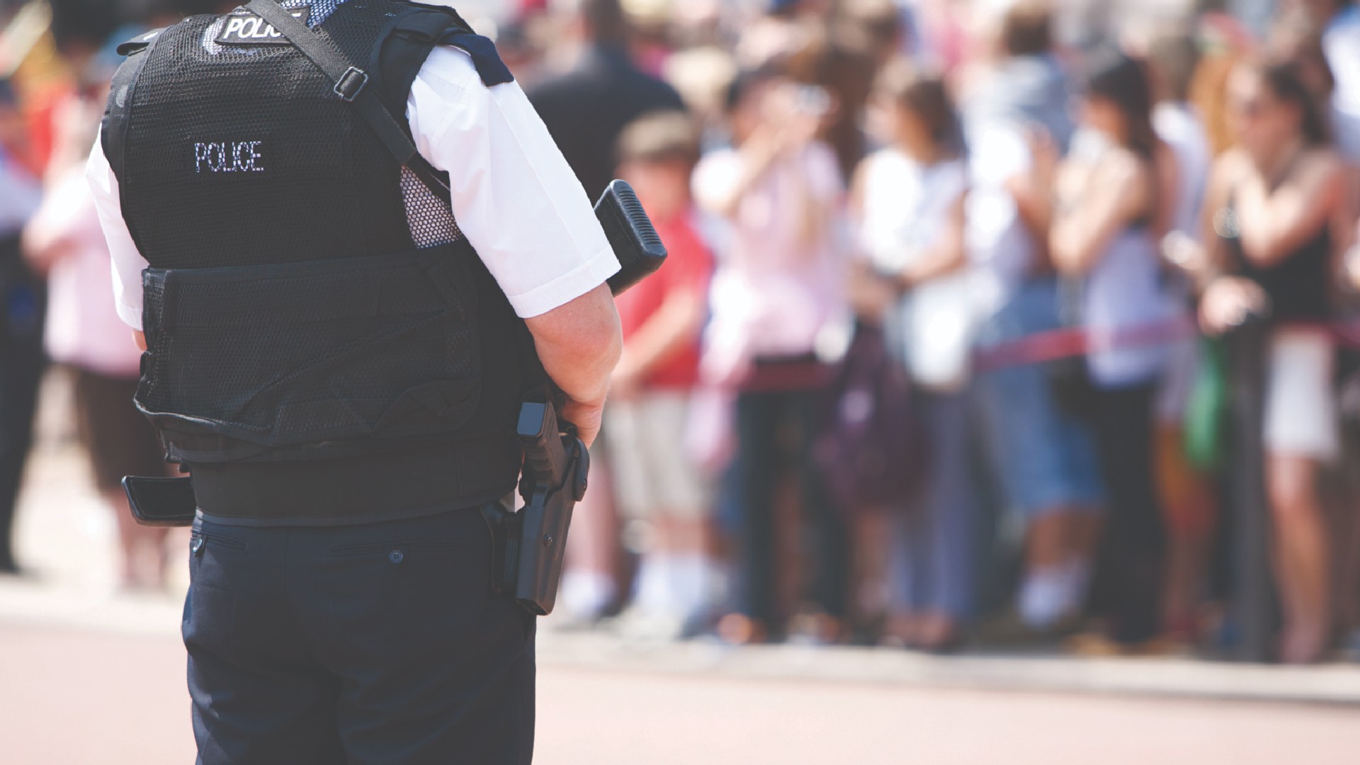 Police officer in front of a crowd