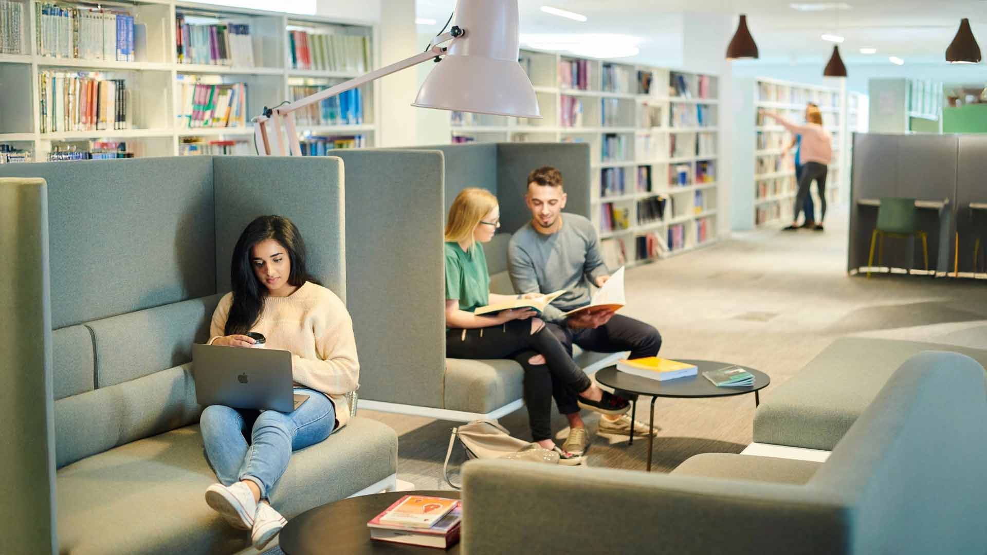 Students sat on sofa with laptop